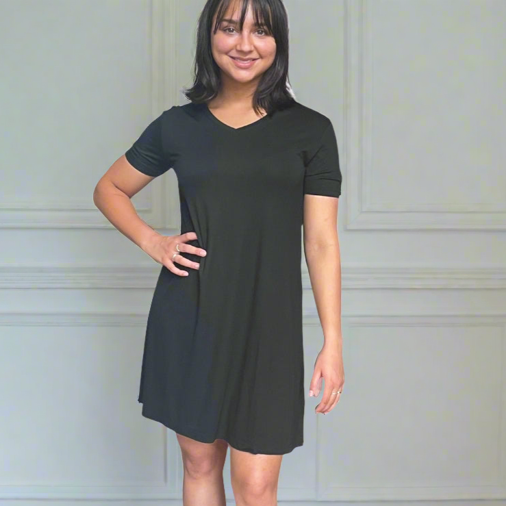 variant::black A young woman with dark hair wearing a black v-neck nightshirt with short sleeves that comes just above the knee. 