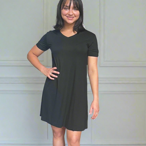 variant::black A young woman with dark hair wearing a black v-neck nightshirt with short sleeves that comes just above the knee. 