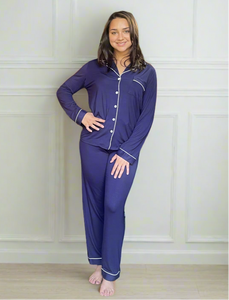 variant::navy Tailored navy pajamas with white piping worn by a young woman with shoulder-length brown hair. 