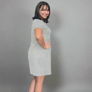 variant::gray A young woman with dark hair wearing a grey v-neck nightshirt with short sleeves that comes just above the knee. She has one hand on her hip. The fabric is Lenzing modal, a cooling fabric that is antibacterial and cooling and made from beech viscose. 
