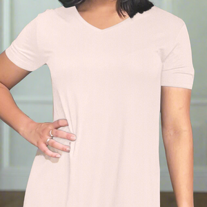 variant::pink Close up view from the neck down of a woman wearng a moisure-wicking pink v-neck Lenzing modal nightgown with short sleeves. 