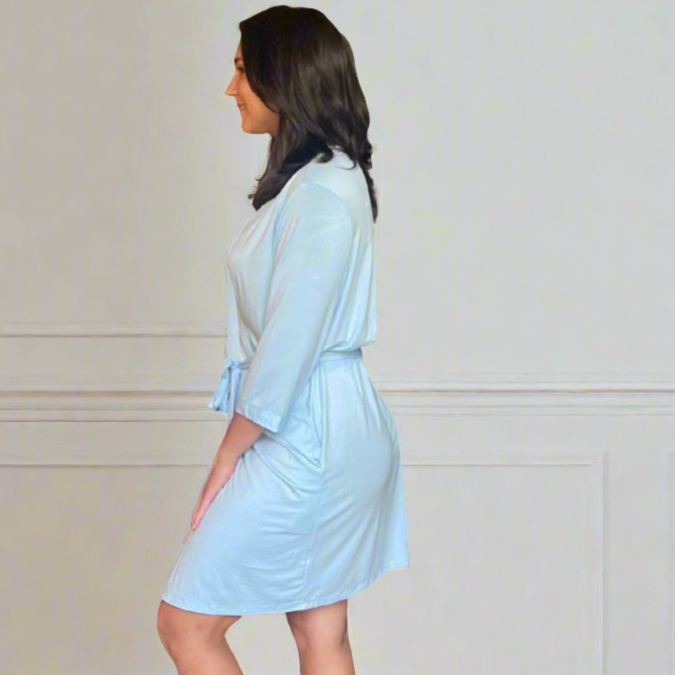 variant::light blue Stretch Knit Bamboo kimono robe worn by a woman with dark hair. Is is a side view. 