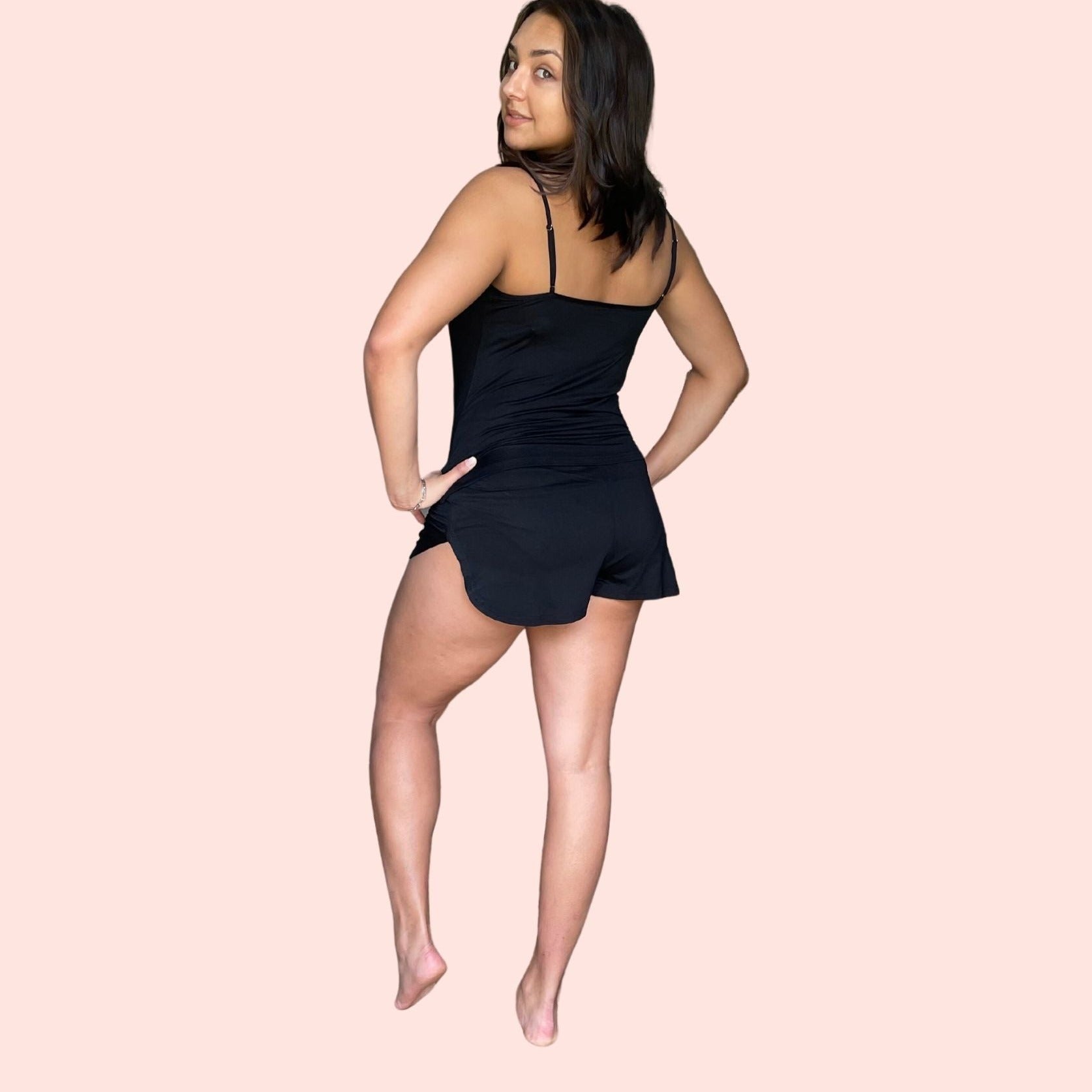 Back view of woman with brown hair  wearing a black bamboo cami set especially designed for menopause relief from hot flashes and night sweats variant::black