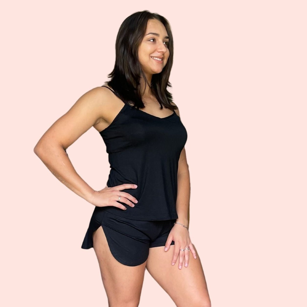 side view of woman with brown hair  wearing a black bamboo cami set especially designed for menopause relief from hot flashes and night sweats variant::black