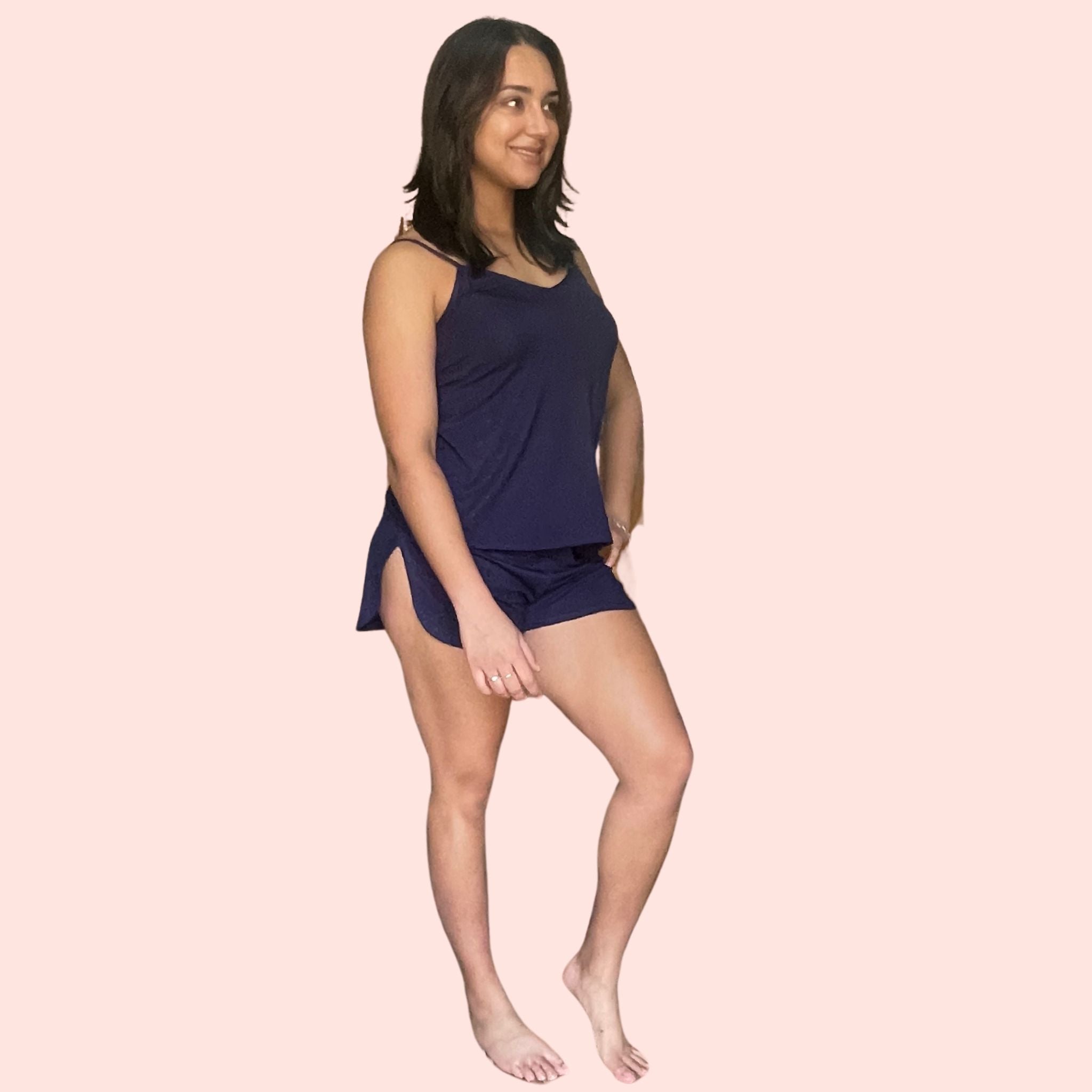 Side view of woman with brown hair  wearing a black bamboo cami set especially designed for menopause relief from hot flashes and night sweats variant::navy