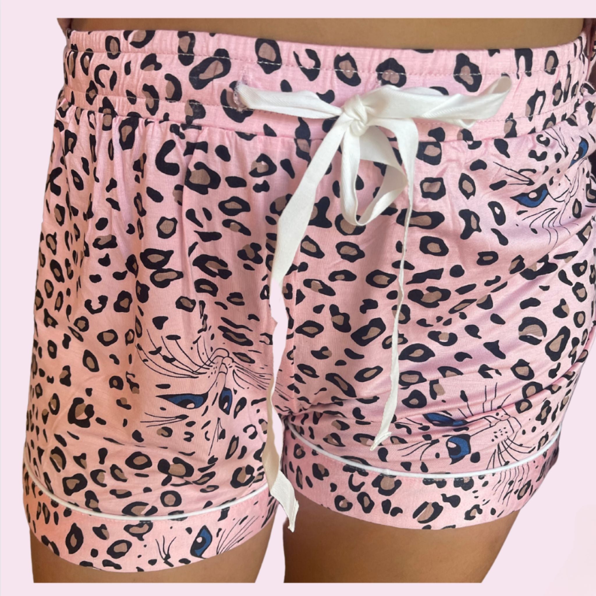 variant::Pink Leopard Pink stretch knit bamboo cheetah print pajamas. Worn by a young woman with brown hair