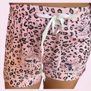 variant::Pink Leopard Pink stretch knit bamboo cheetah print pajamas. Worn by a young woman with brown hair