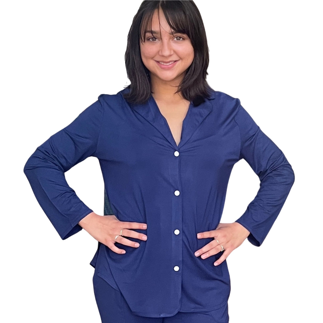 variant:all Woman with dark brown hair and both  hands on her hips. She is wearing the Live-In Blue lenzing modal/ Bamboo pajama shirt with Velcro closure. Modal/bamboo is great at wicking moisture away and suitable for night sweats.